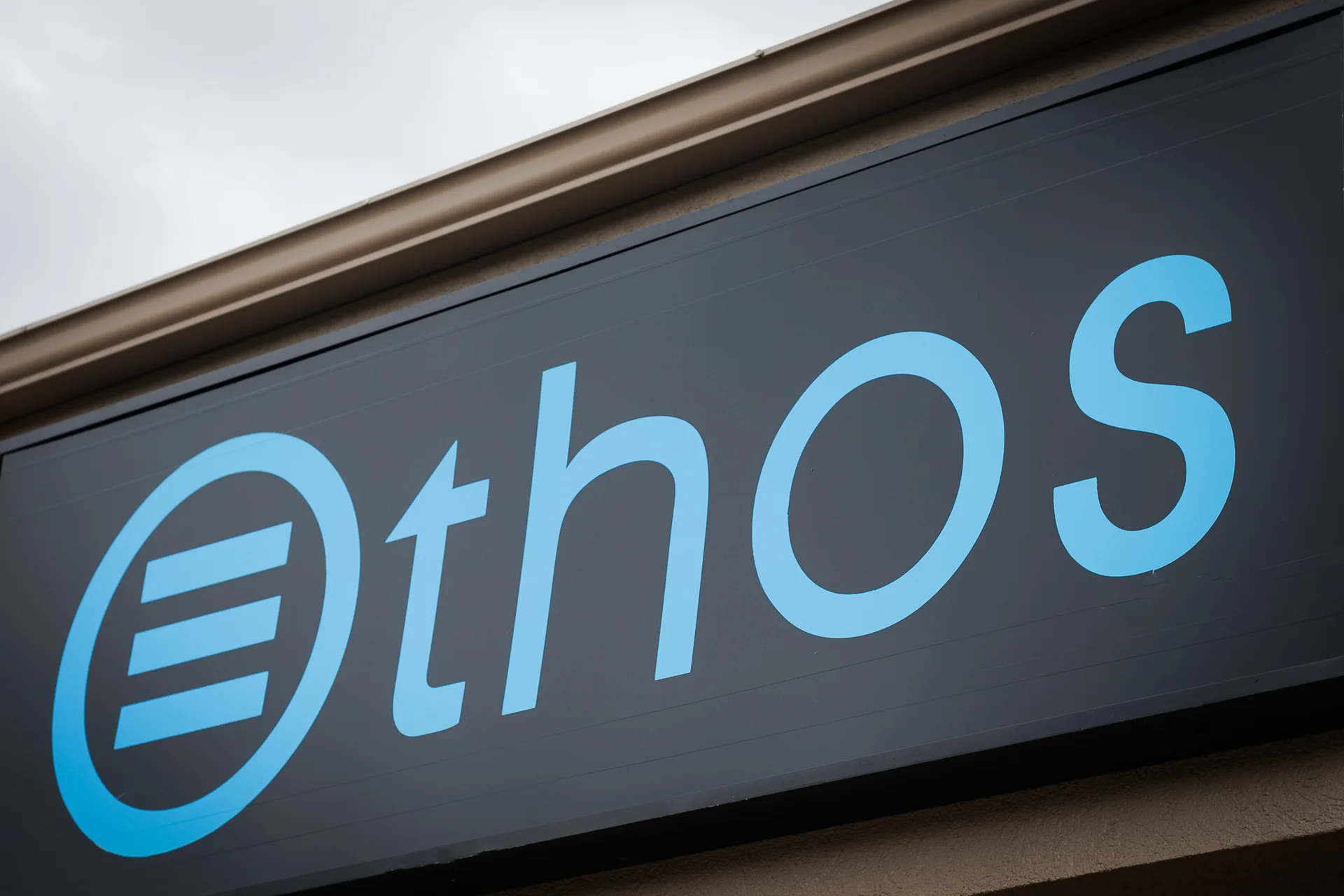 Blue Ethos wordmark on the studio exterior sign